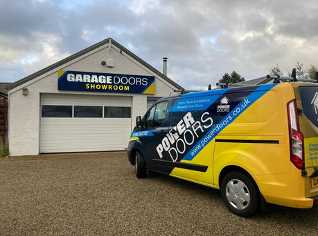power doors branded van outside garage doors showroom in glasgow