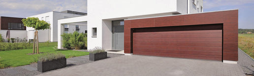 chestnut wooden garage door attached to white house